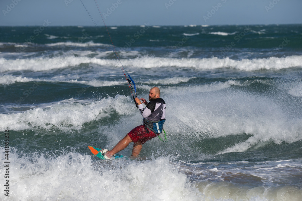 Overweight kitesurfer on the waves of the sea in Mui Ne beach, Phan Thiet, Binh Thuan, Vietnam Overweight kitesurfer on the waves of the sea in Mui Ne beach, Phan Thiet, Binh Thuan, Vietnam