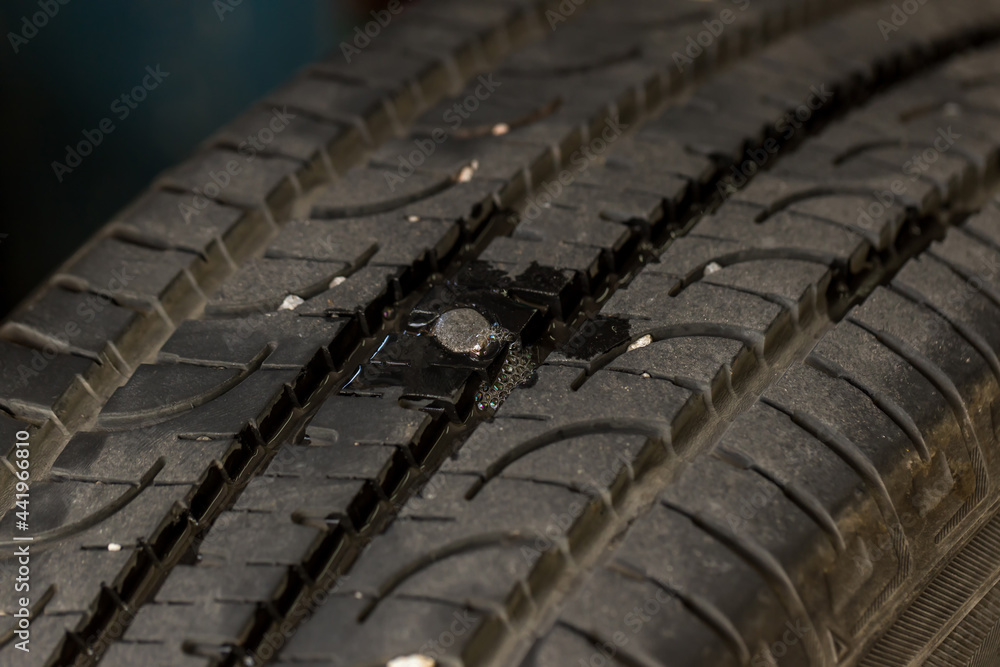 Deep embedded of screw nail on the tire. screw puncturing tire. Tire