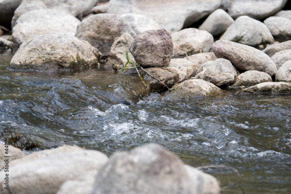 Stream flowing through white rocks,unfocused shooting Stream flowing through white rocks,unfocused shooting
