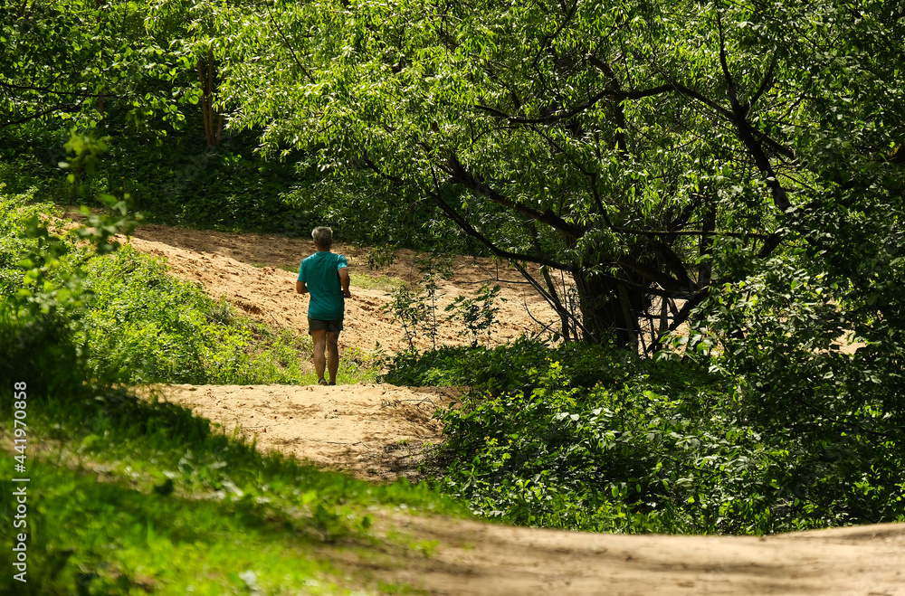 man jogging in forest