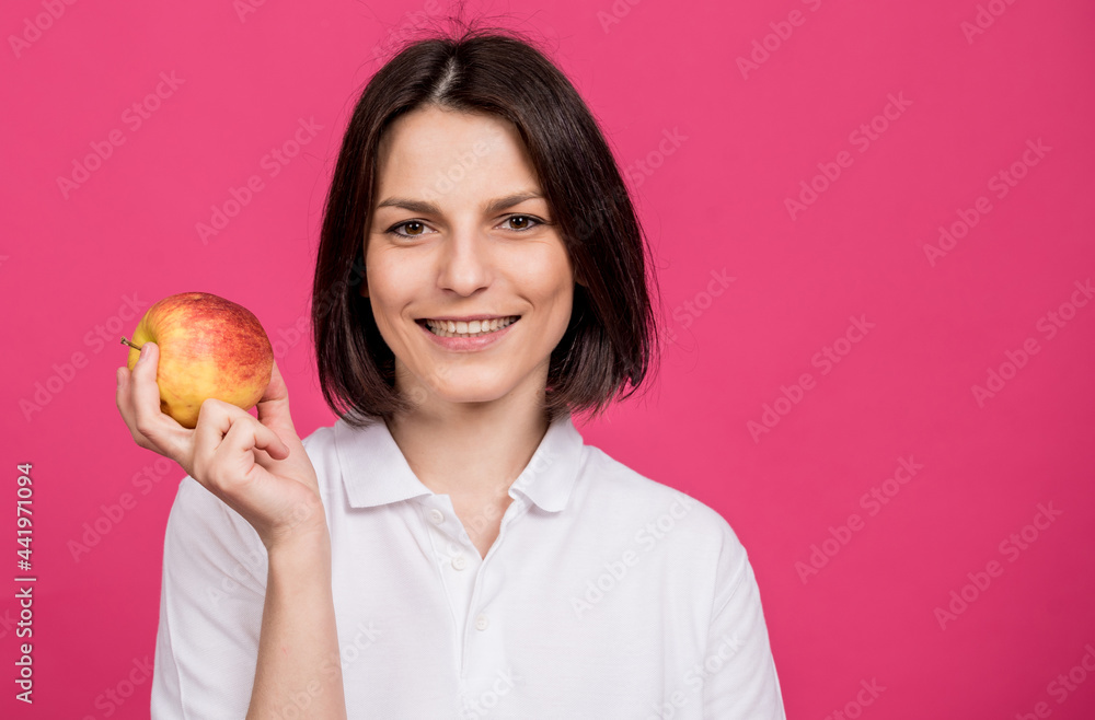 Beautiful young woman hold a big apple in her hand Beautiful young woman hold a big apple in her hand