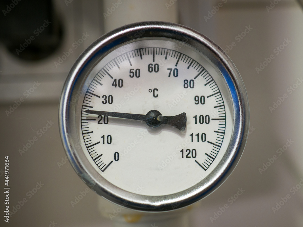 A temperature gauge showing the water temperature in the pipeline system in a private house. - obrazy, fototapety, plakaty 
