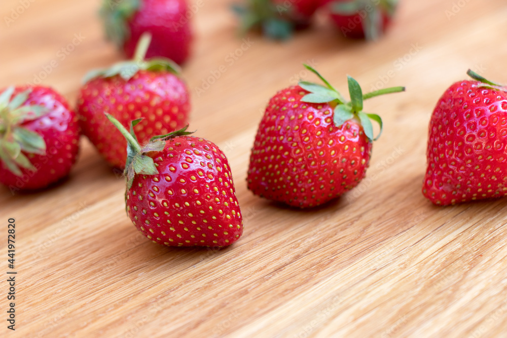 Fresh strawberries with leaf on wooden background. Side view set. Full depth of field.