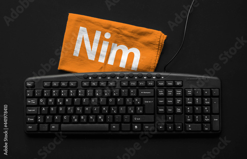 Nim programming language. Rag width word Nim and pc keyboard.
