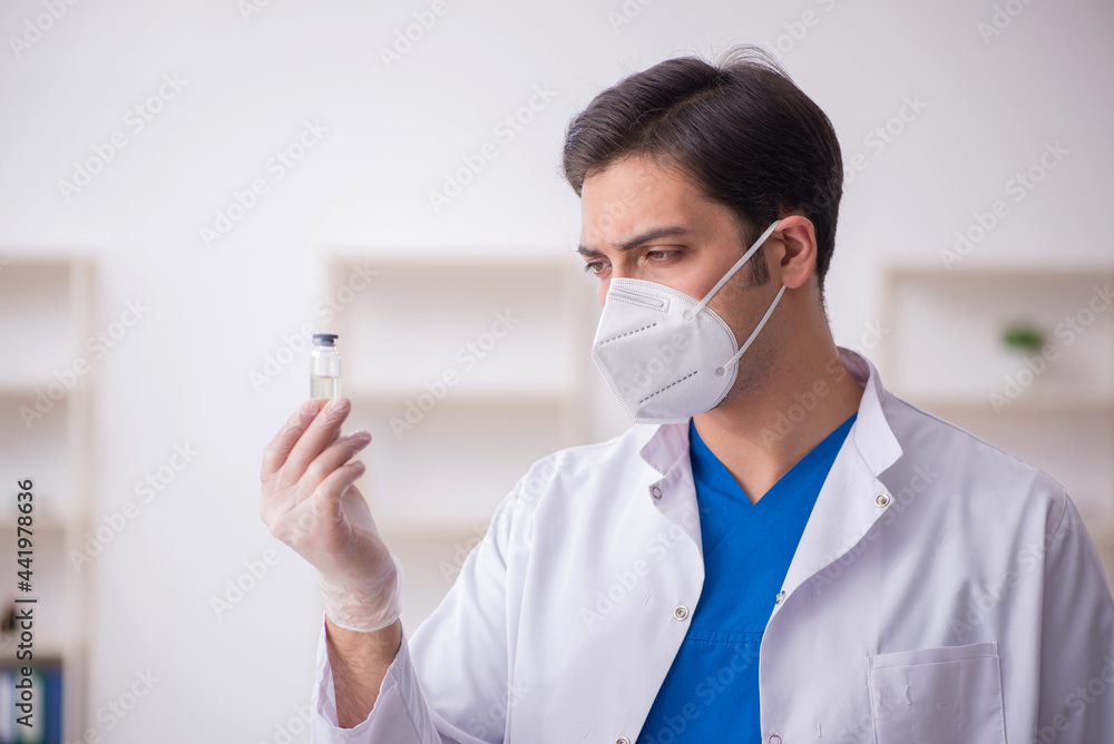 Young male doctor in vaccination concept