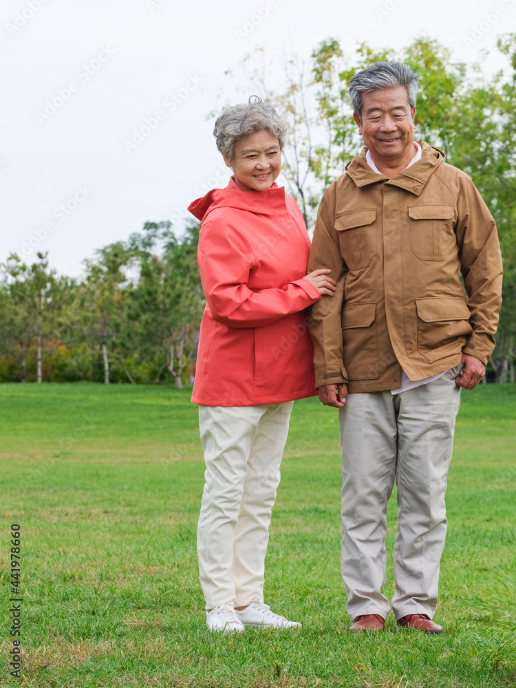 Happy old couple taking photos in the park Happy old couple taking photos in the park