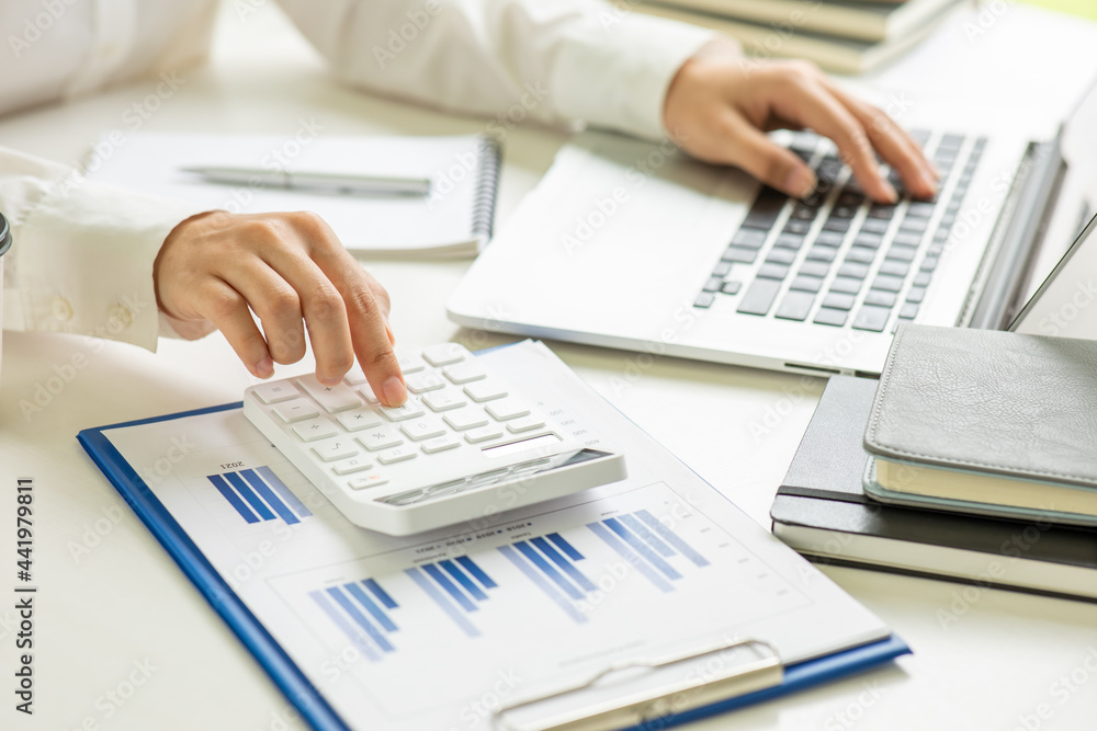 Businessmen are calculating income-expenditure and analyzing real estate investment data, Accounting Financial and tax systems concept. Businessmen are calculating income-expenditure and analyzing real estate investment data, Accounting Financial and tax systems concept.