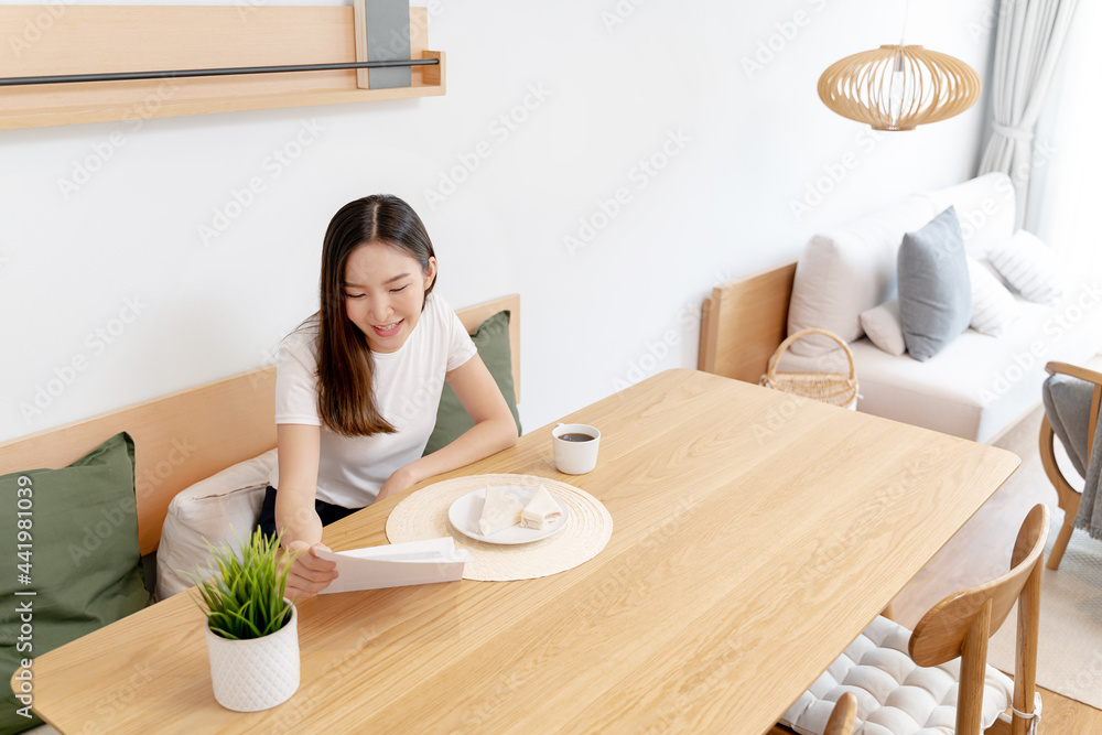 Asian woman eating lunch while working from home