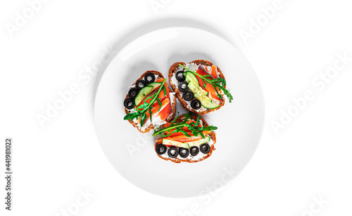 Bruschetta with cream cheese, salmon and vegetables isolated on a white background. Toasts isolated. Sandwich isolated. Sandwich with salmon and cheese.