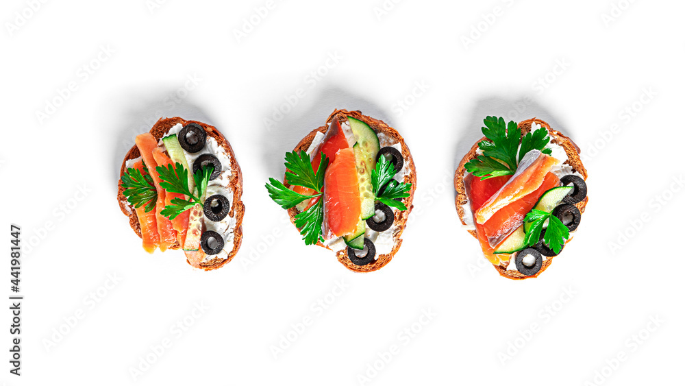 Bruschetta with cream cheese, salmon and vegetables isolated on a white background. Toasts isolated. Sandwich isolated. Sandwich with salmon and cheese.