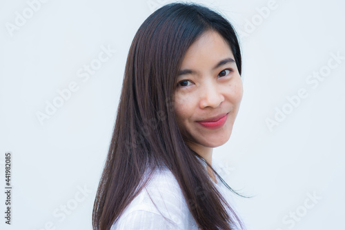 close up attractive adult business woman asian girl with happy and smile against white concrete wall office. © thithawat