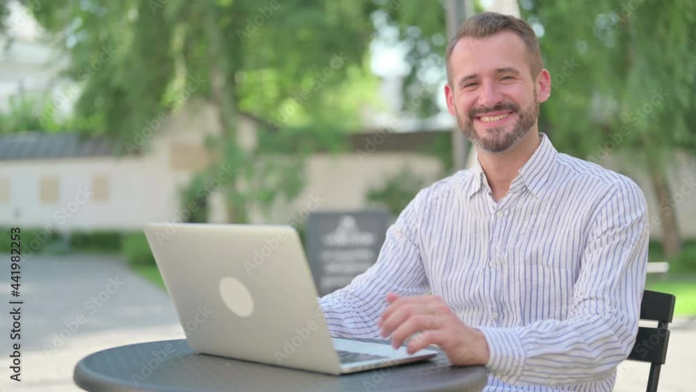 Middle Aged Man with Laptop Smiling at Camera Outdoor Middle Aged Man with Laptop Smiling at Camera Outdoor