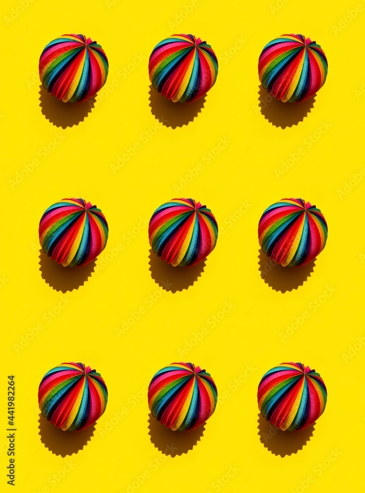 Geometric pattern of  Rainbow Sphere on a bright yellow background, top view