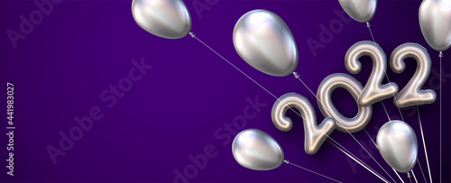 Bundle of 2022 with silver balloons on violet background.