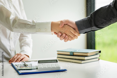 Handshake of businesspeople. Female and male hand makes a handshake in the office.