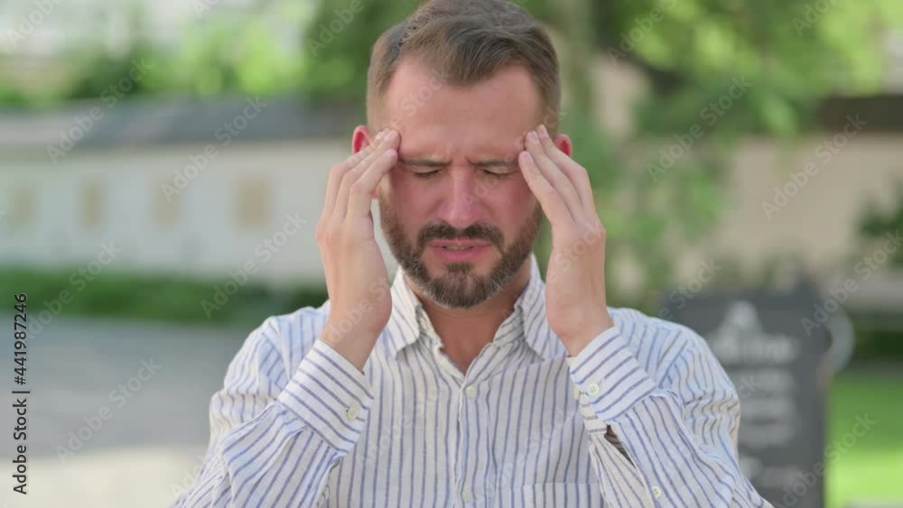 Outdoor Portrait of Middle Aged Man having Headache Outdoor Portrait of Middle Aged Man having Headache
