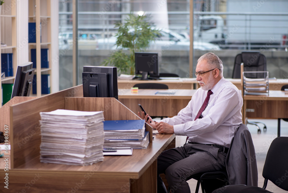 Old businessman employee and too much work in the office Old businessman employee and too much work in the office