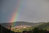  rainbow and heavy rain over the mountain valley