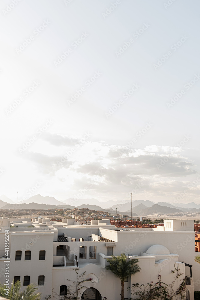 Modern oriental buildings with white walls and picturesque view. Tropical eastern architecture design concept background Modern oriental buildings with white walls and picturesque view. Tropical eastern architecture design concept background