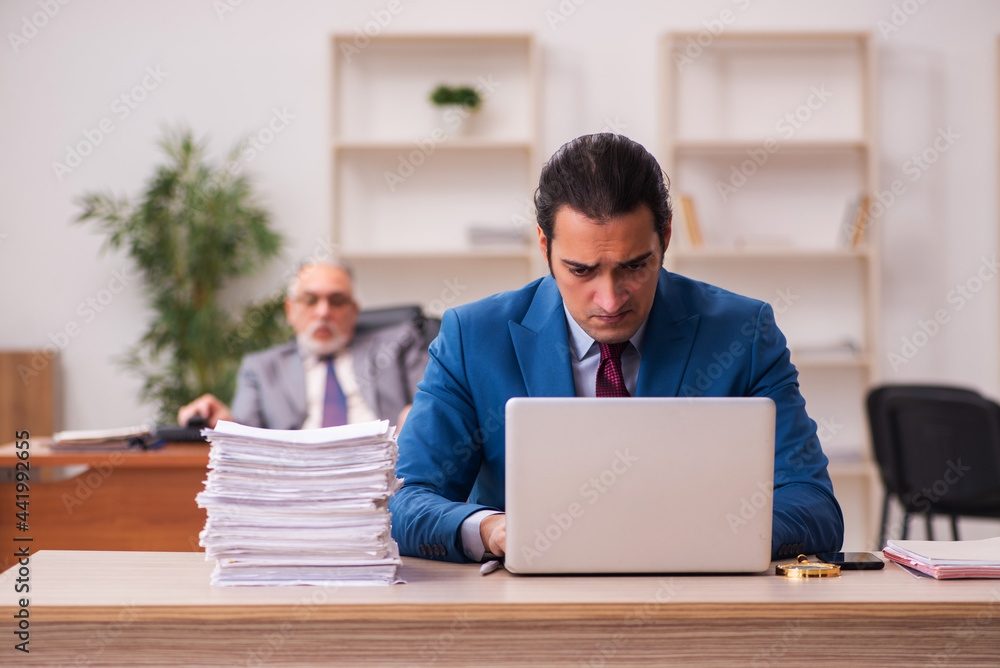 Two employees working in the office Two employees working in the office
