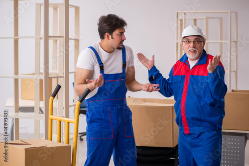 Two male professional movers doing home relocation © Elnur
