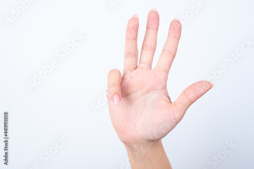 Woman's hand with pink manicure over isolated white background 
