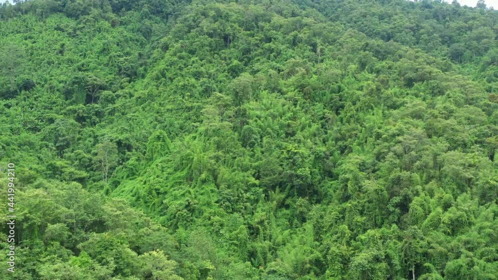 Aerial view flying above lush green tropical rain forest mountain the rainy season on the Doi Phuka Mountain reserve national park the Nan province northern Thailand. Aerial view flying above lush green tropical rain forest mountain the rainy season on the Doi Phuka Mountain reserve national park the Nan province northern Thailand.