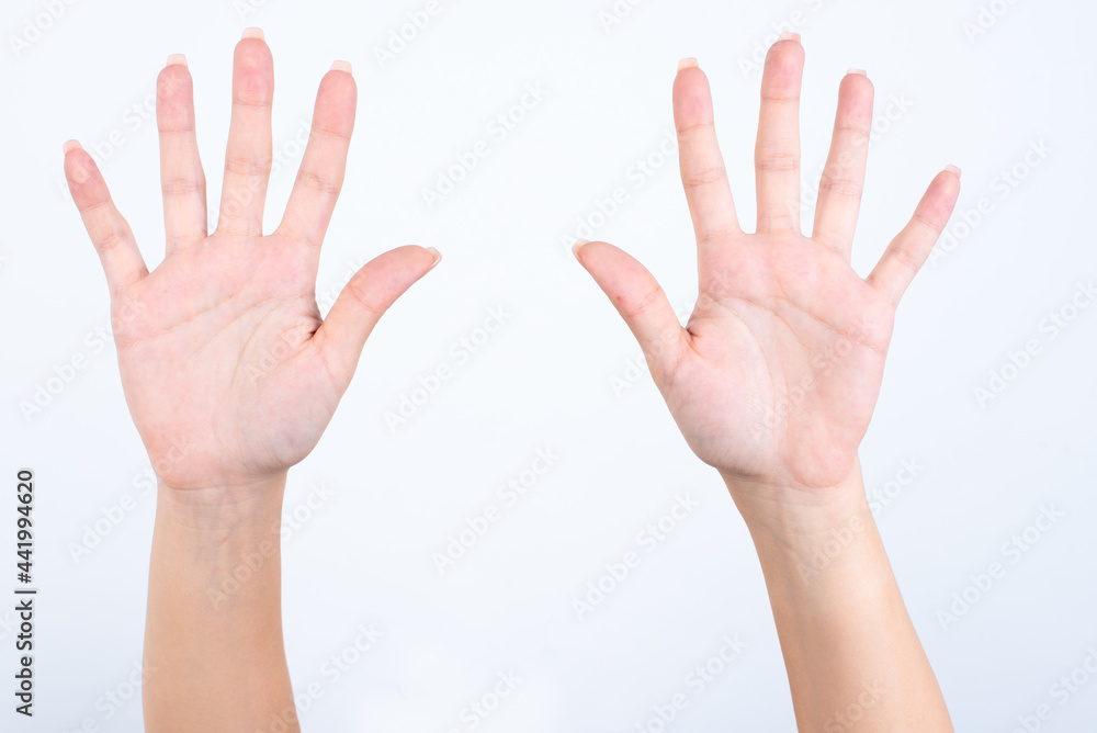 hands with pink manicure over white background pointing up with fingers number ten. hands with pink manicure over white background pointing up with fingers number ten.