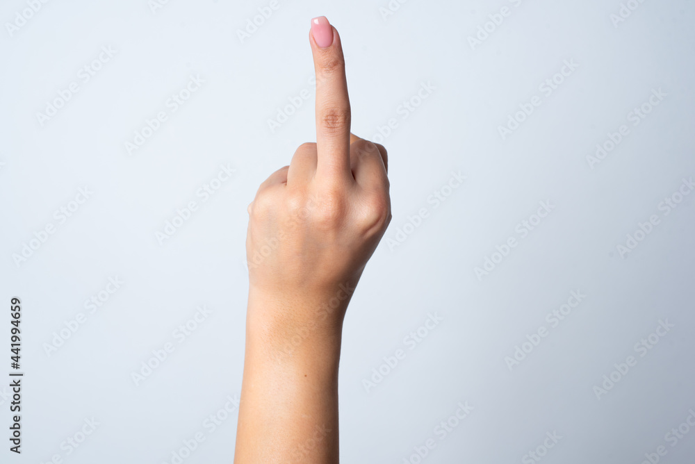 hand pointing up with middle finger, concept of rude hand sign or hand gesture, studio isolated over white background. hand pointing up with middle finger, concept of rude hand sign or hand gesture, studio isolated over white background.