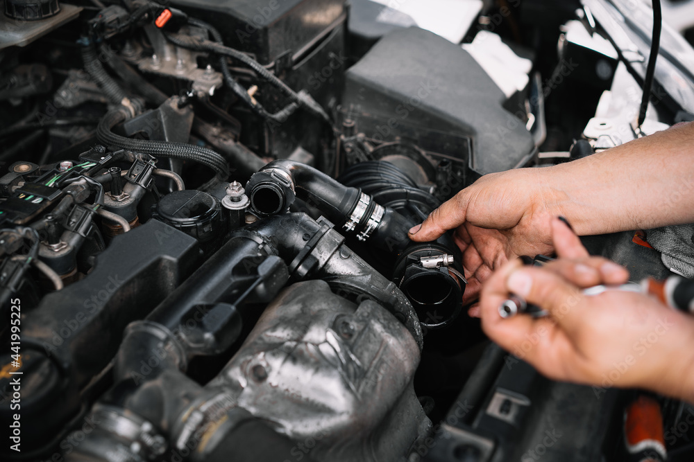 Mechanic repairing car engine Mechanic repairing car engine