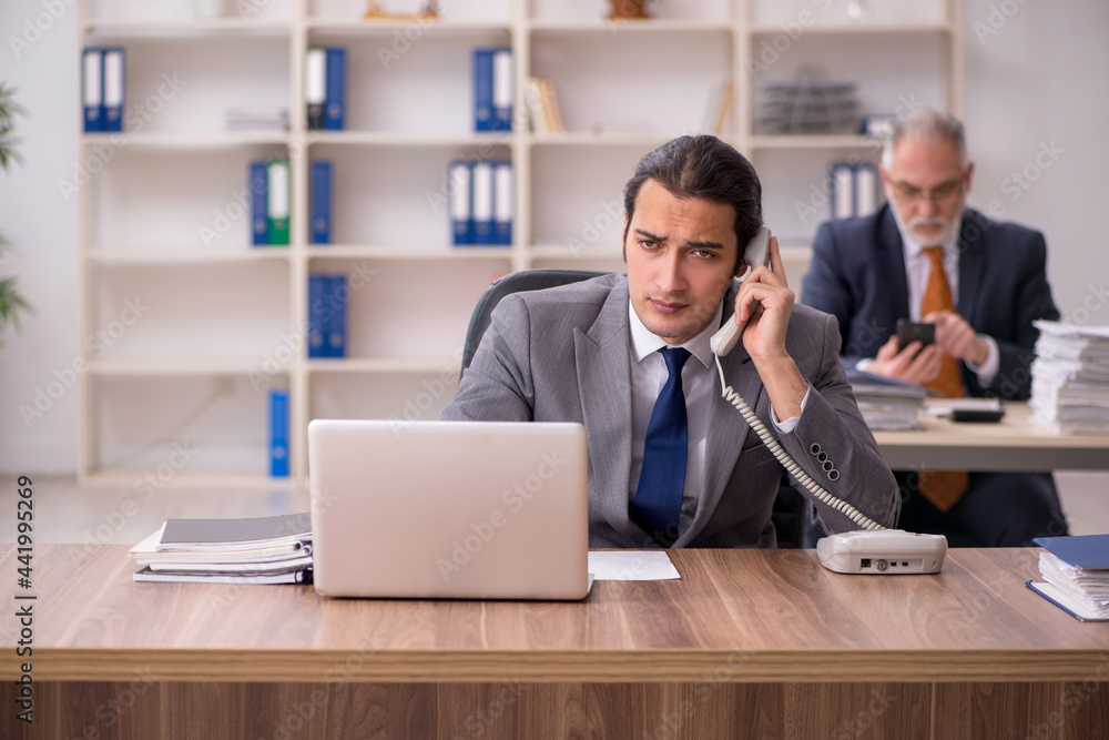 Two employees sitting at workplace Two employees sitting at workplace