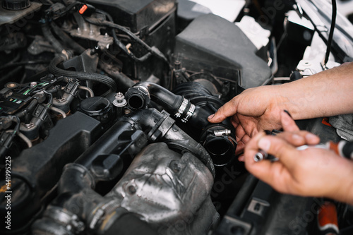 Mechanic repairing car engine © adrianad