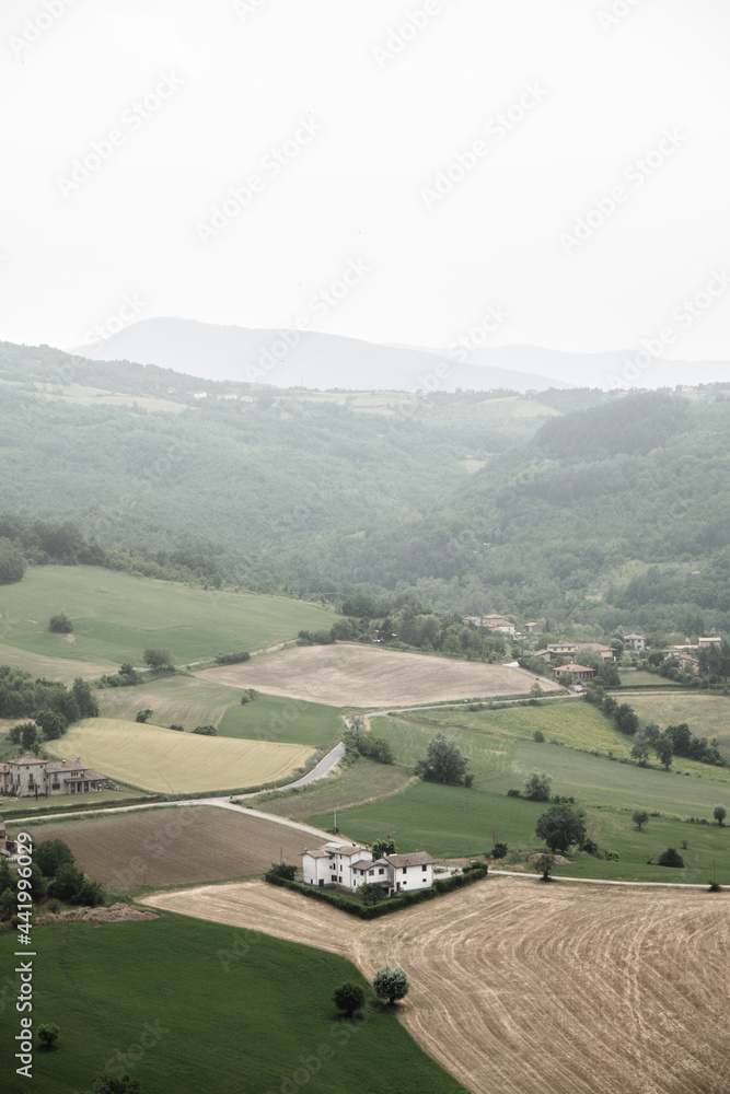 Aerial view of countryside with hills and farm in the small village of 