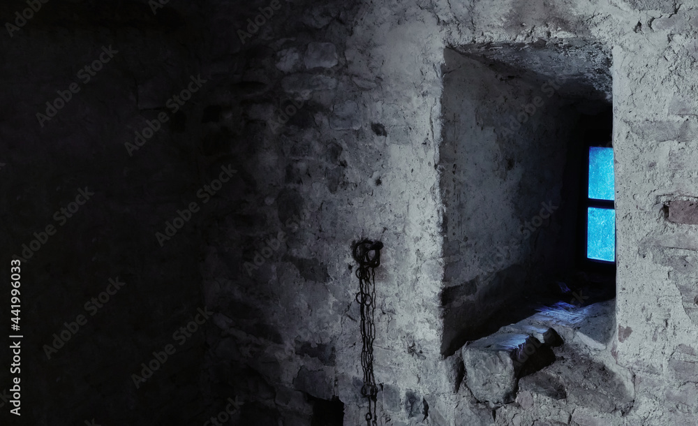 interior view of medieval old prison with chain and window - searching for freedom concept. interior view of medieval old prison with chain and window - searching for freedom concept.