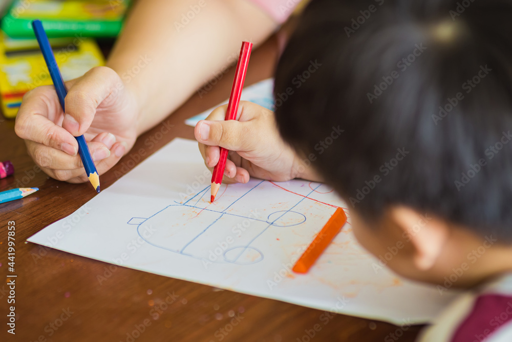 Mother teaching her son to doing homework. Concept for homeschool learning and education in period of coronavirus or covid-19 spreading. Mother teaching her son to doing homework. Concept for homeschool learning and education in period of coronavirus or covid-19 spreading.