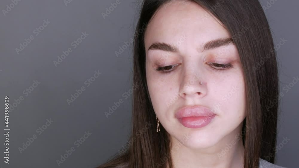Young beautiful woman model posing in front of the camera. Girl with big lips and extended eyelashes and brown eyes without makeup Young beautiful woman model posing in front of the camera. Girl with big lips and extended eyelashes and brown eyes without makeup