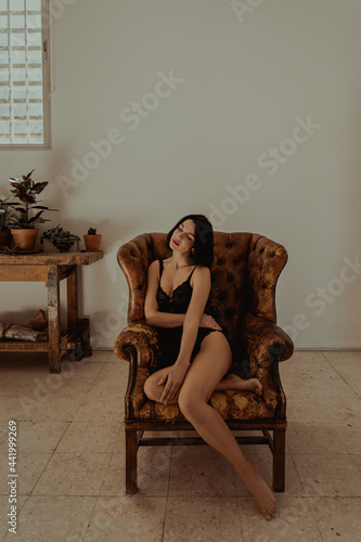 Calm woman resting in leather armchair photo