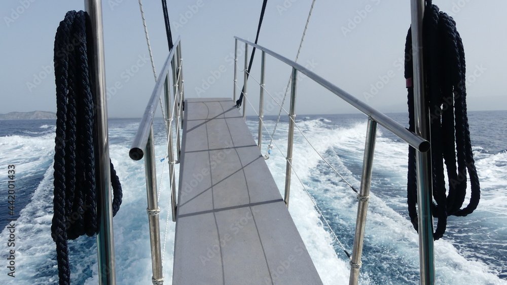 Ramp suspended in air on the back of a speed boat traveling thru the ...