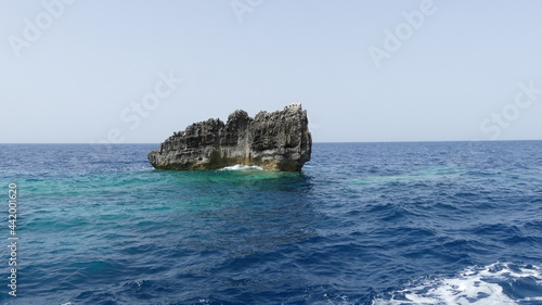 Rock formation in Greek ocean with sky