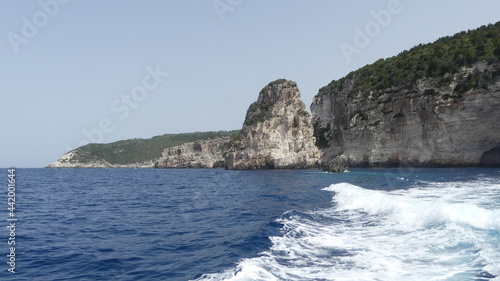 sea and rocks with boat wake in Greece