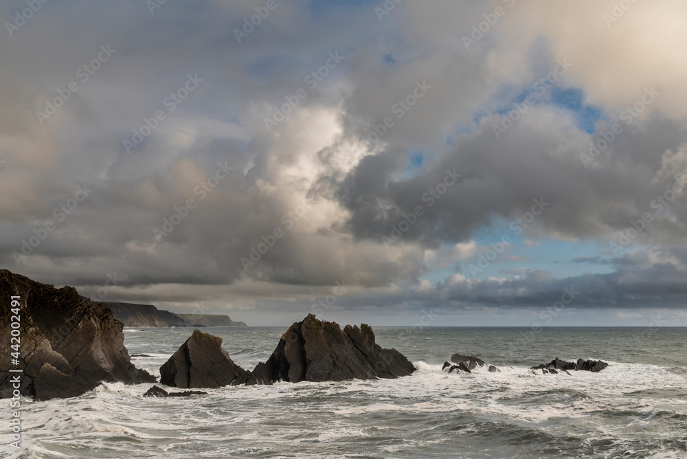 Stunning landscape image of view from Hartland Quay in Devon England durinbg moody Spring sunset