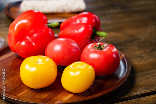 yellow and red tomatoes and bell pepper with water drops. food blogger, stylist