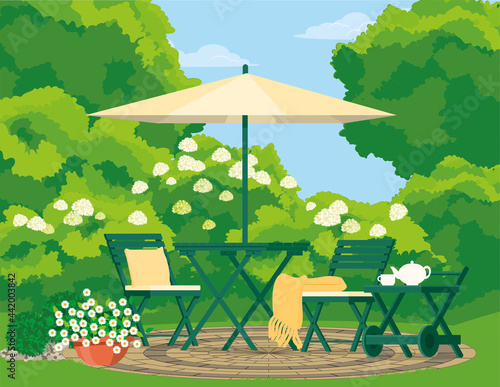Cozy backyard with garden furniture in the greenery of the garden.