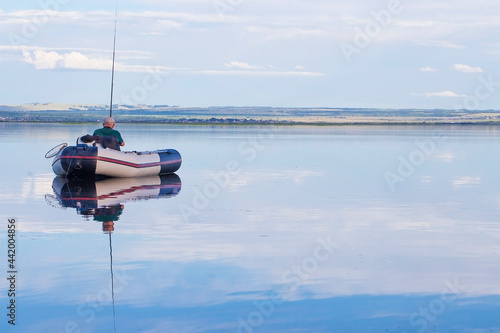 Adult male fisherman in a boat at daytime
