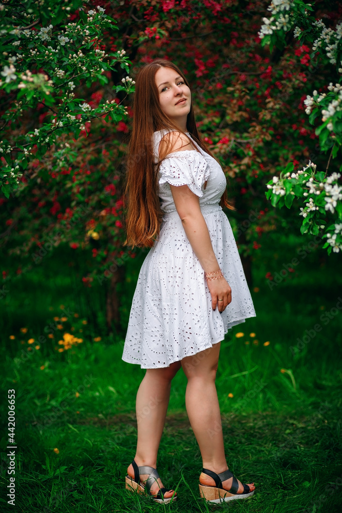 A happy girl in the park, in a white dress. Summer Park. Beautiful long hair. A happy girl in the park, in a white dress. Summer Park. Beautiful long hair.