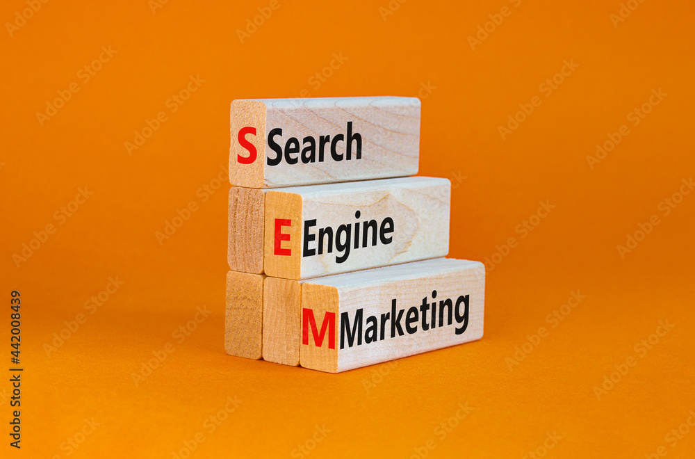 Naklejka premium SEM search engine marketing symbol. Wooden blocks with words 'SEM search engine marketing' on beautiful orange background, copy space. Business, SEM search engine marketing concept.