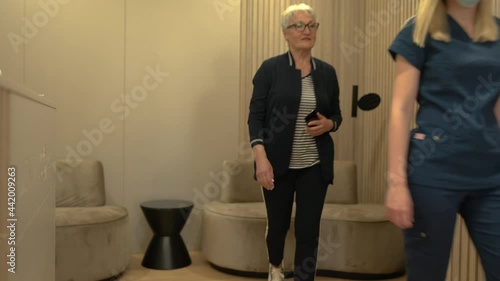 Dentist greeting patient in a waiting room