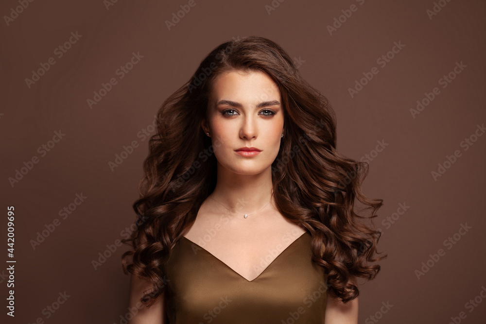 Beautiful curly hair model. Woman with wavy long hairstyle portrait. Volume Beautiful curly hair model. Woman with wavy long hairstyle portrait. Volume