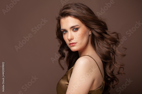 Portrait of a beautiful woman with a long brown hair