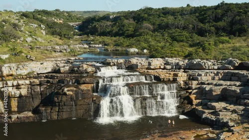 Aerial view of a couple swimming in the magnificent Horseshoe Falls which plunge into the sea, Mkambati Nature Reserve, Eastern Cape, South Africa photo